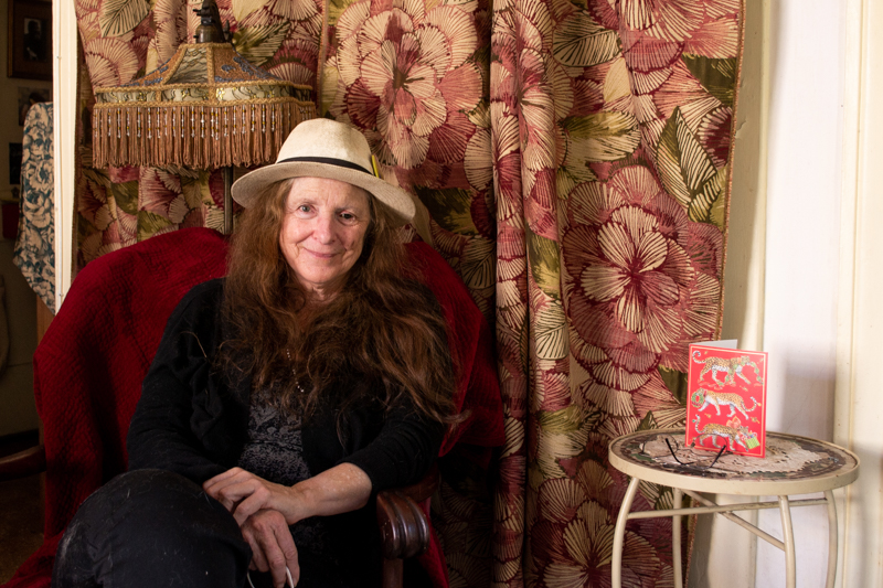 A woman sitting in her ecovillage home.