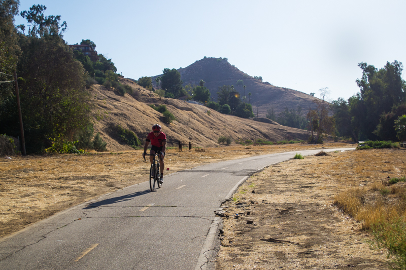 A biker pedals on the Santa Ana River Trail.